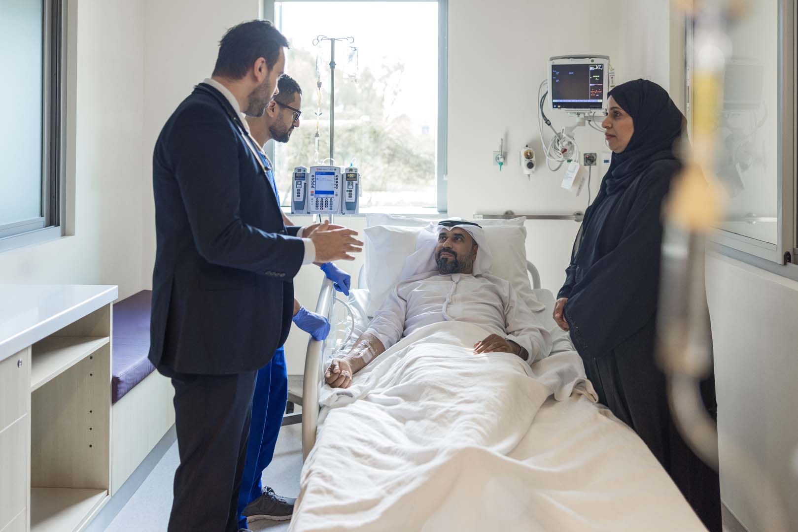 Hospital Room with Patient and Medical Staff